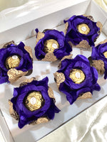 Decorative  royal blue roses flowers with gold mesh holding a chocolate in a box of 6 roses.
