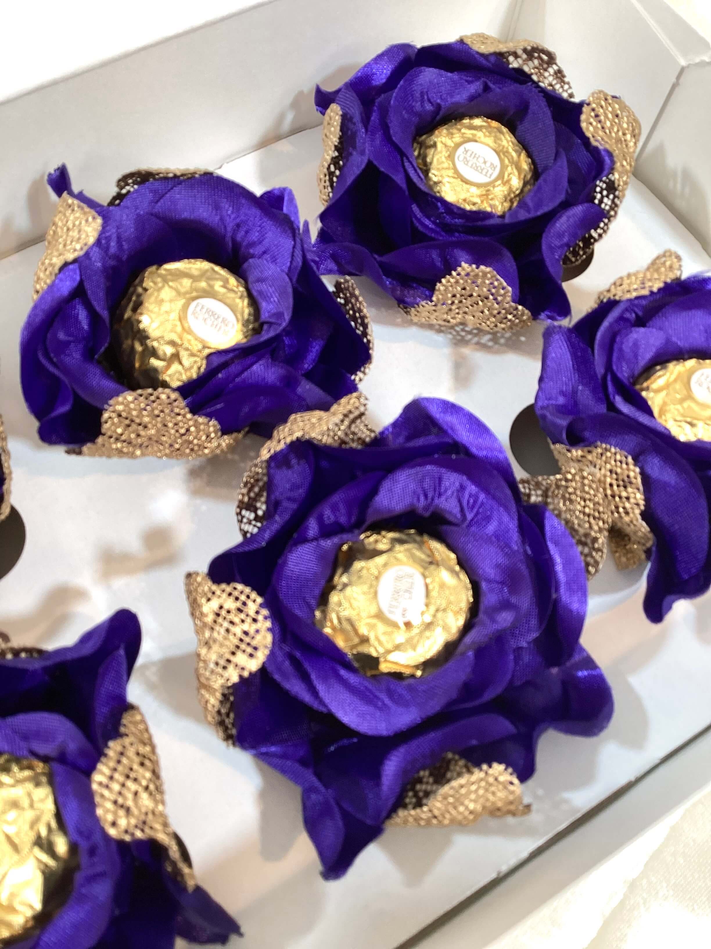  royal blue flowers with gold mesh arranged in a box