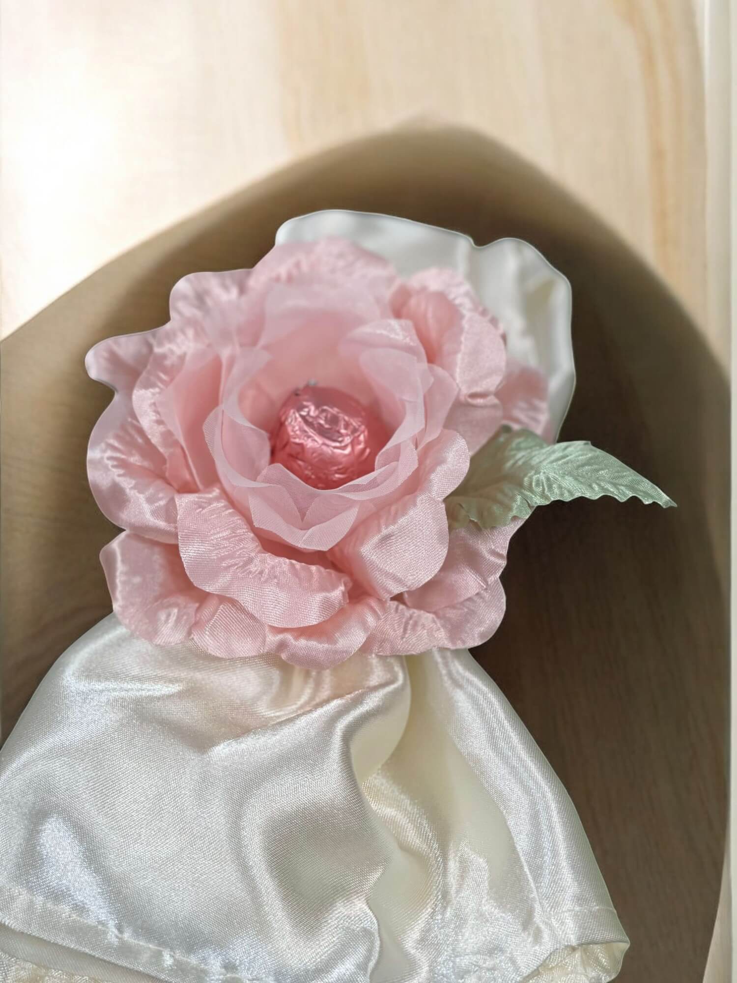 Pink flower on a white fabric background