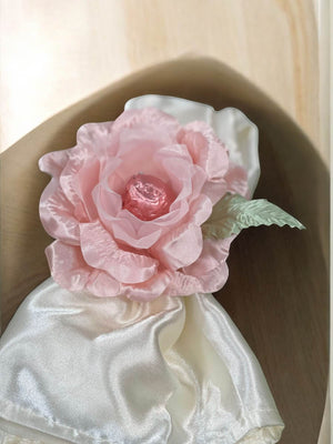 Pink flower on a white fabric background