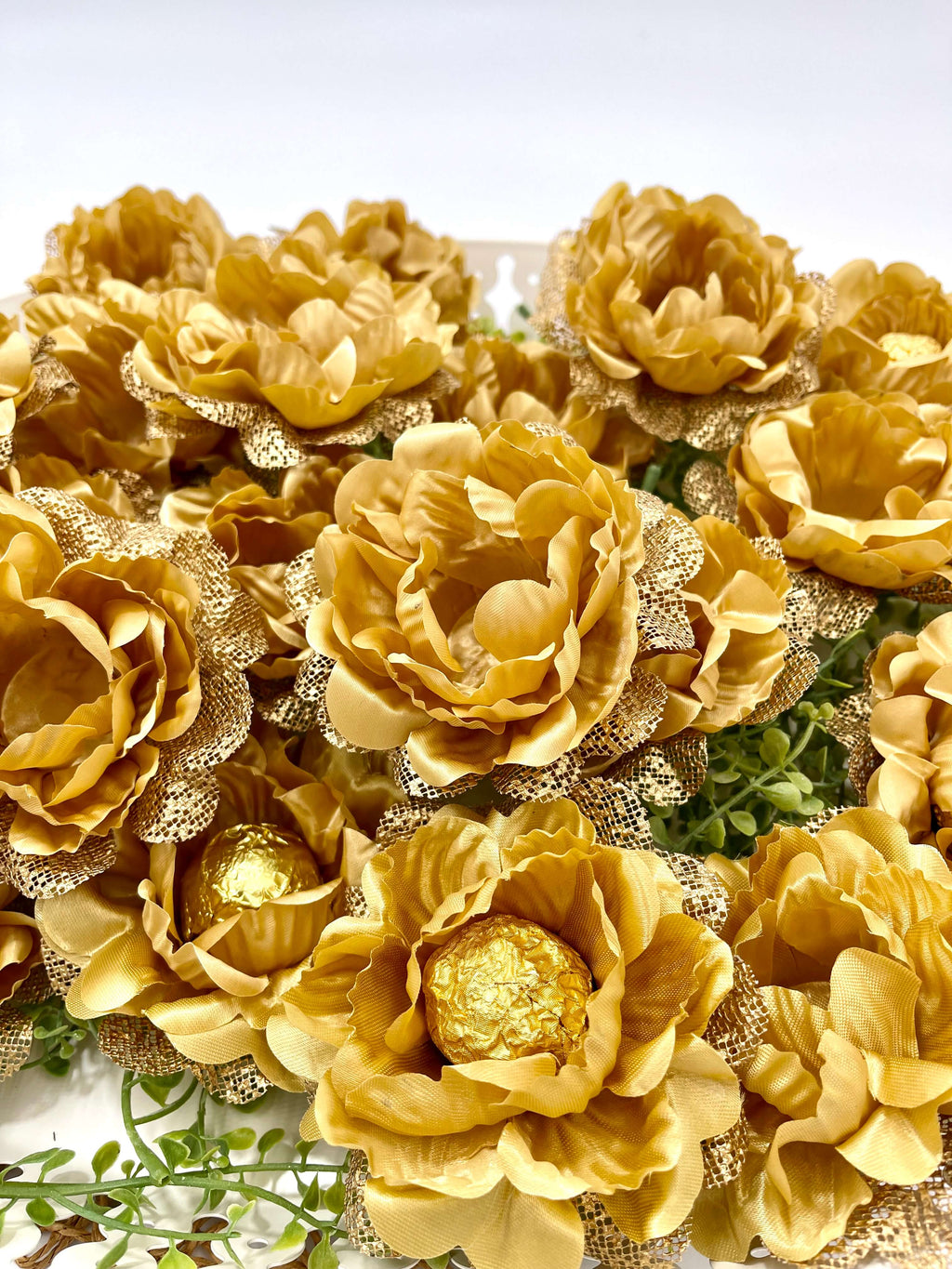 gold flowers sweet holders. Fabric flower holding chocolates as party decor and favor for guests
