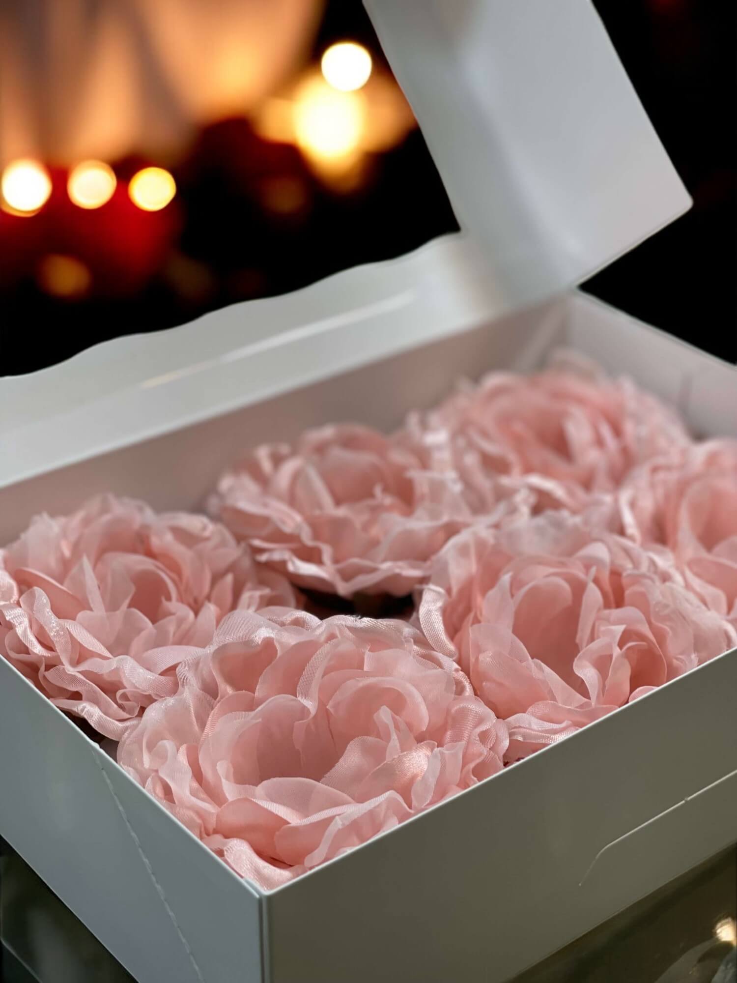Box of pink flowers with a blurred warm light background