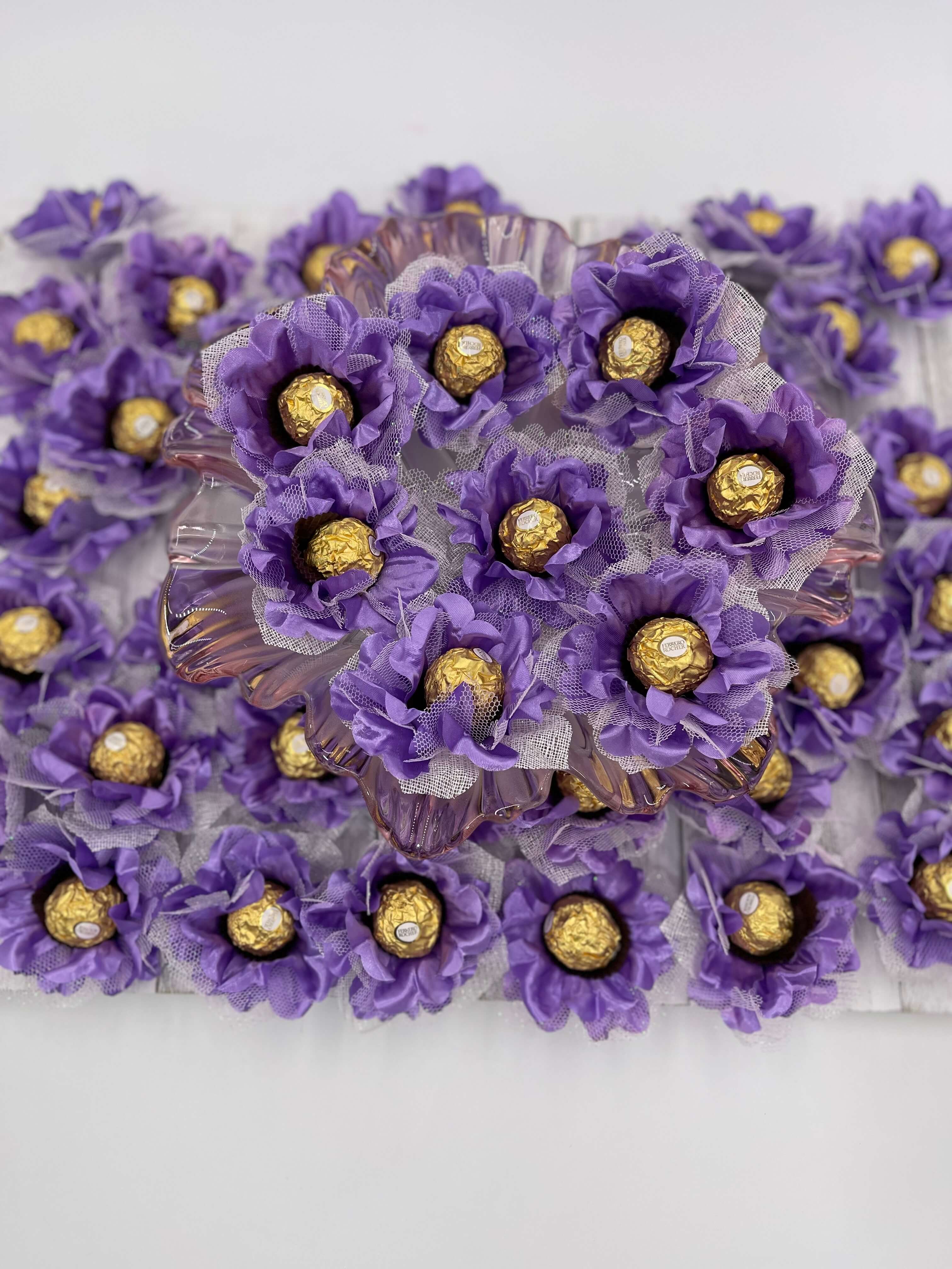 A close-up of purple silk flowers with gold chocolate, designed for events and parties.