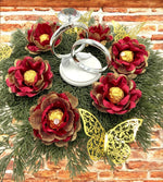 red and gold flowers holding a gold chocolate centeerpiece