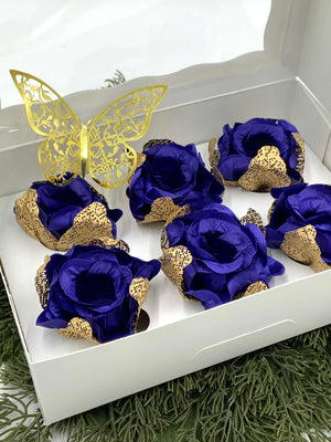 Decorative set of  royal blue and gold flowers with a butterfly on a white box.